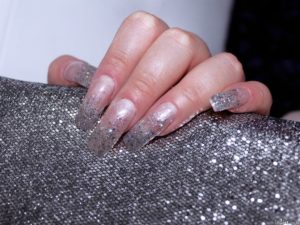 Sexually lacquered nails and glitters applied on them