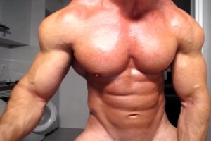 Muscular man showing abs on webcam
